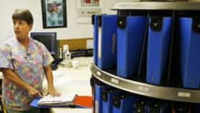 Several blue binders containing medical records in a health-care setting.