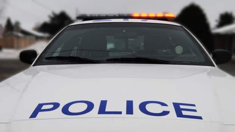 A police cruiser sits unmanned in a residential neighbourhood.