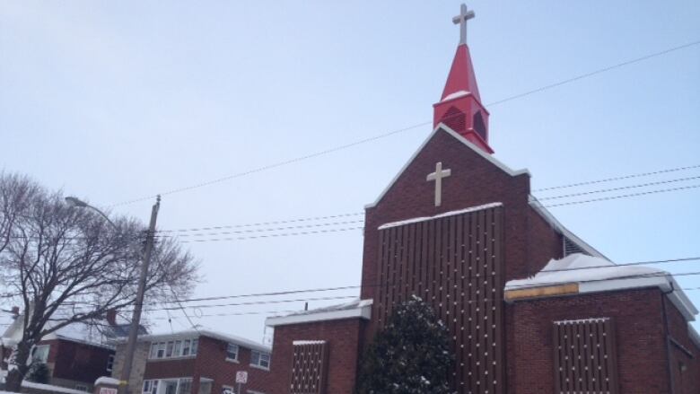 A building with gothic style architecture on a snowy day.