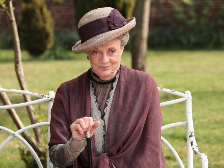 An older woman in period piece clothing