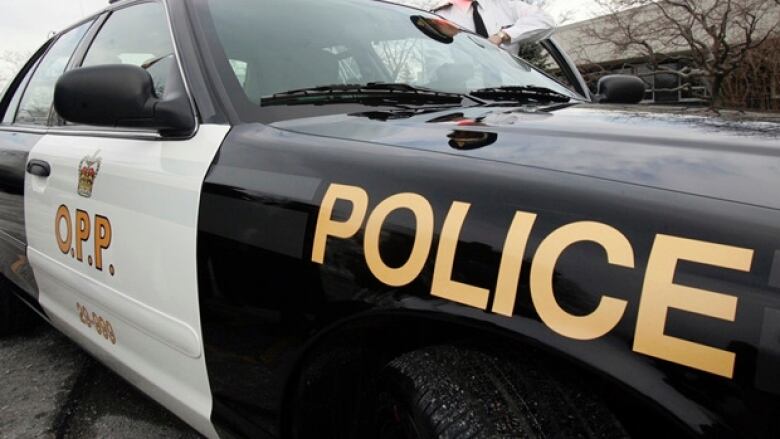 A close-up image of a white and black police cruiser. 