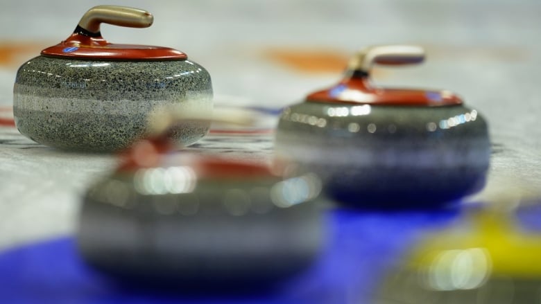 A group of curling stones are pictured.