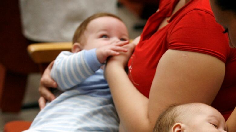 An image of a person breastfeeding a baby.