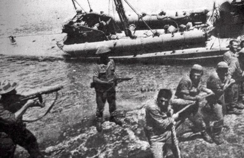 In this file photo dated July 20 1974, Turkish troops pull ashore a Greek Cypriot torpedo boat damaged during fighting in Kyrenia on the day Turkey invaded and occupied the northern third of Cyprus.