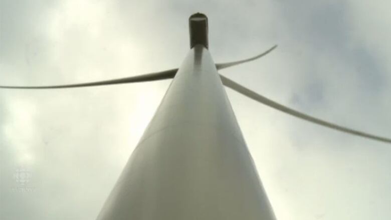 A view of one of the wind turbines, looking straight up from the ground.