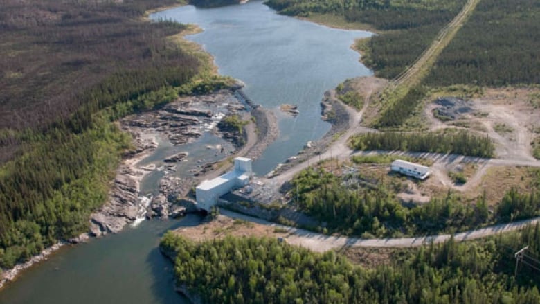 Aerial view of a hydroelectric dam and water reservoir.