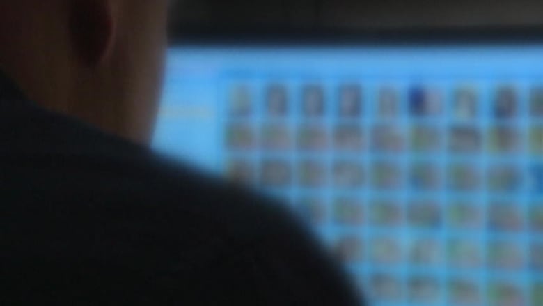 Someone looks at a computer screen that is out of focus. 