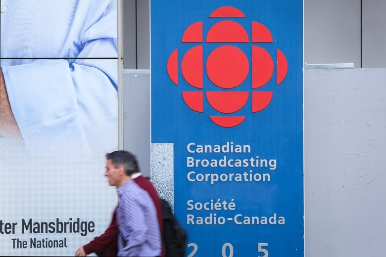 People walk past the CBC Broadcasting Centre in downtown Toronto.