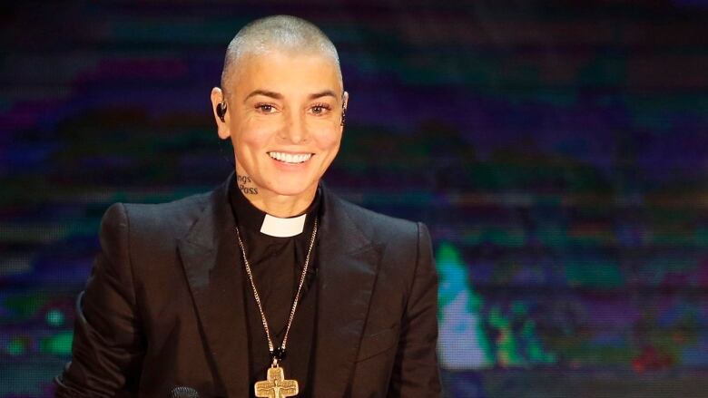 Sinead O'Connor in a priest-like outfit.