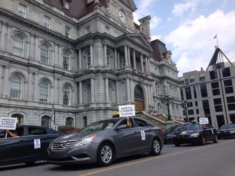 Taxi drivers waving signs that read 