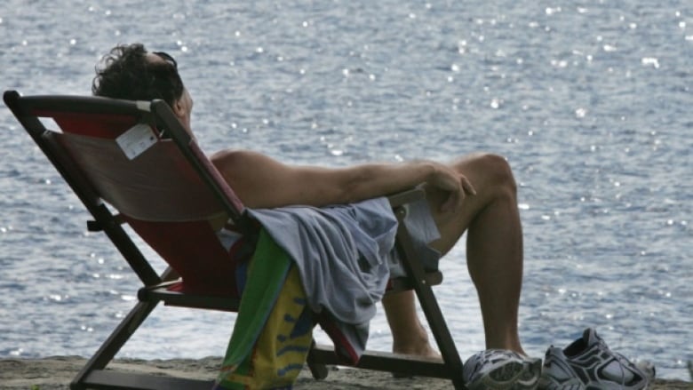 Man tanning on beach.