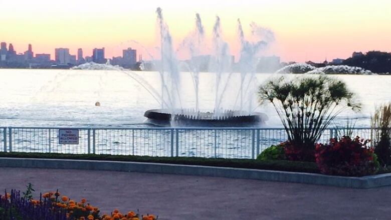 A picture of a fountain at sunset