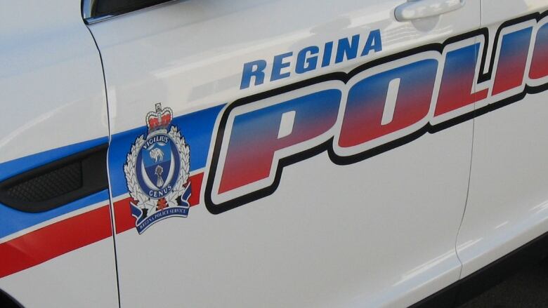 A closeup shows the door of a Regina Police Service vehicle.