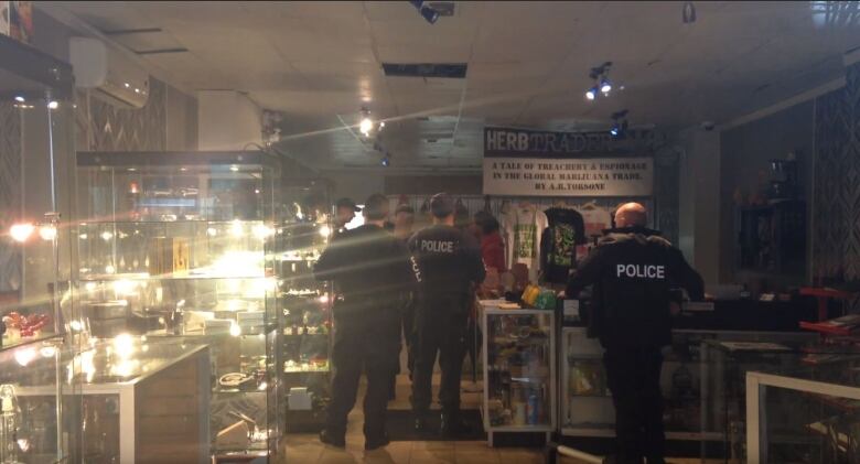 Police officers are shown inside a business.