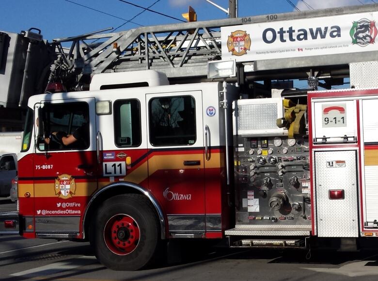 A fire truck, seen from one side.