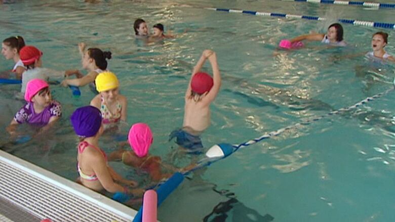 Children swim in an indoor pool