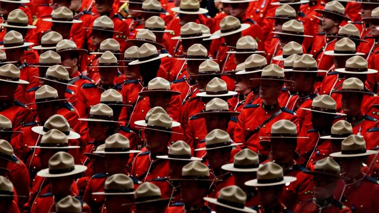 Row upon row of Mounties in red serge wearing their traditional stetson hats.