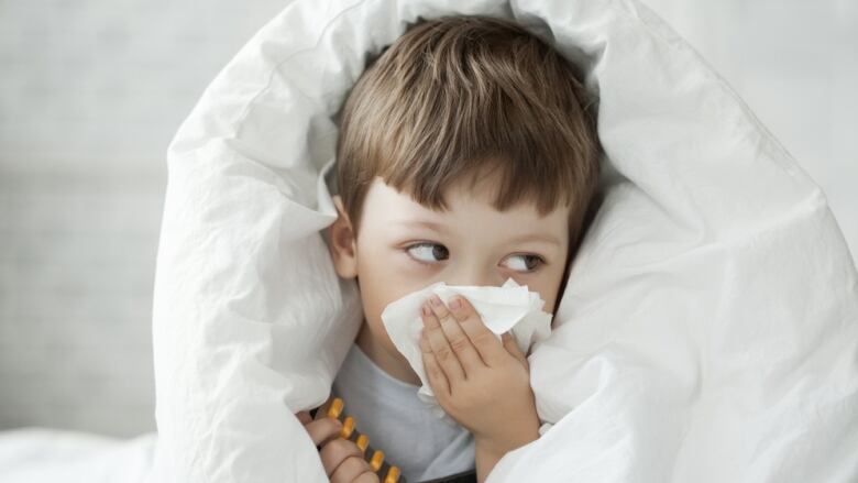 A child blows his nose.