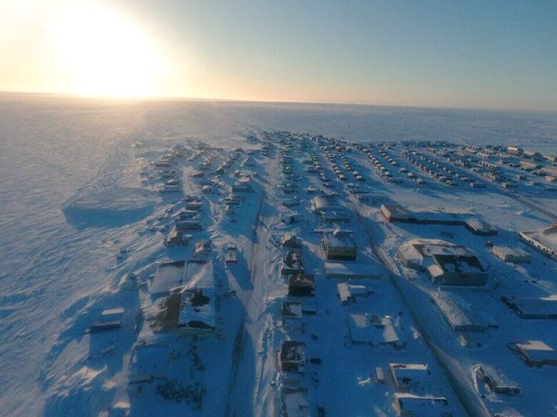 An aerial view of an Arctic hamlet in winter.