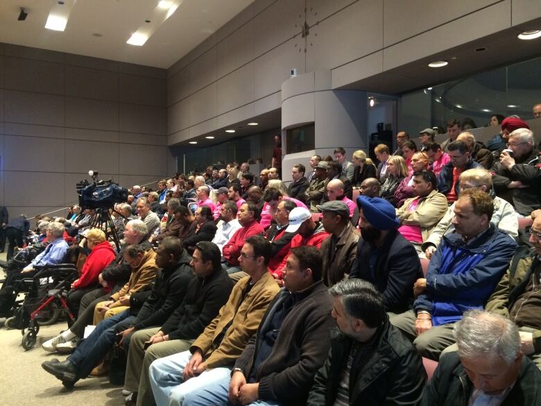 A packed City Hall chamber.