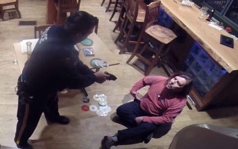 A screen capture of RCMP Cst. Mark Thomaes and Bruce Webb from security footage in the Purple Leprechaun Roadhouse in Bayport, NS from Feb. 28, 2016.