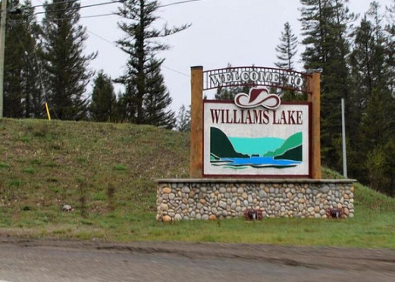 A welcome sign has a lake with a cowboy on top. It says 