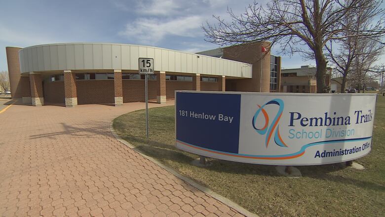 Exterior of a building with a sign on the front lawn that says Pembina Trails School Division