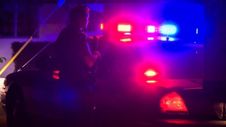 Stock Image - Coquitlam RCMP Cruiser and Officer outside of a crime scene