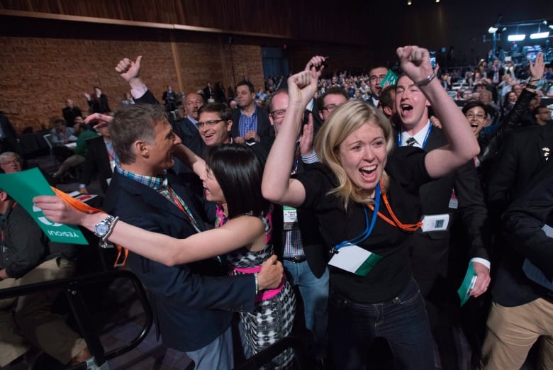 Delegates Michelle Rebel and Natalie Pon celebrate the yes vote to change the wording of the traditional definition of marriage in the conservative policies at the Conservative Party of Canada convention in Vancouver, Saturday, May 28, 2016.