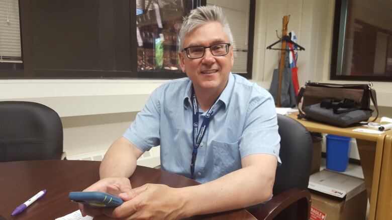 A man sitting at a desk.