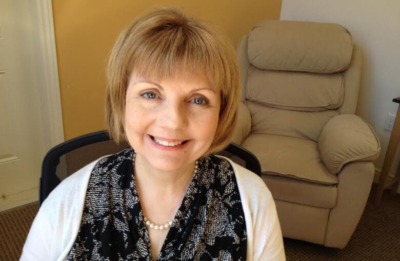 A smiling woman with short brown hair.