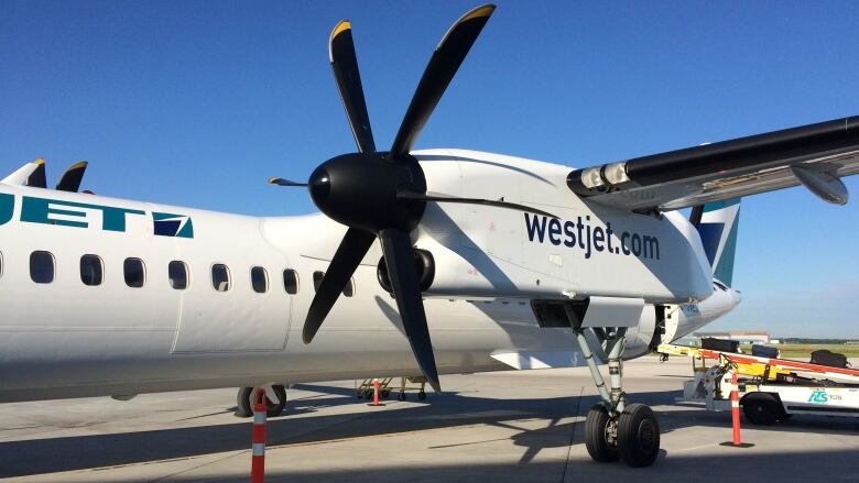 A turboprop plane sits on a runway.