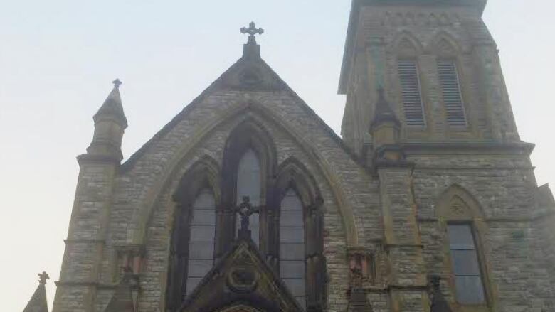 A stone church with a red entryway