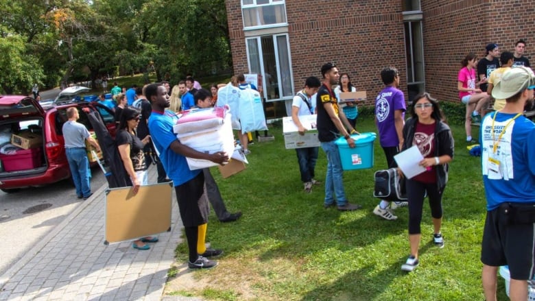 University students moving their belongings into residence