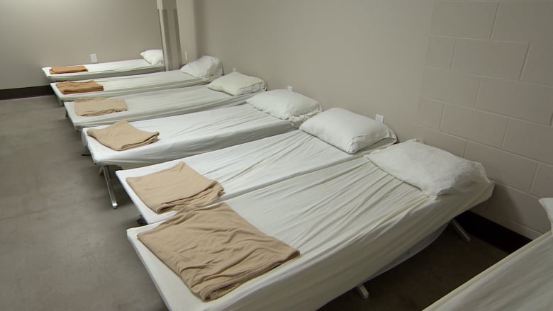 A row of beds in a room.