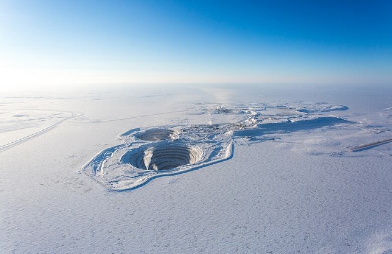 Aerial photo of an opening mining pit in the winter.