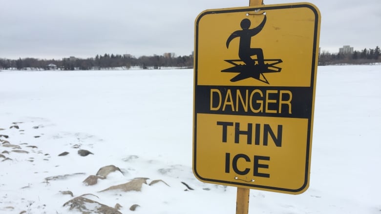 A danger sign for thin ice on a lake in the winter. 