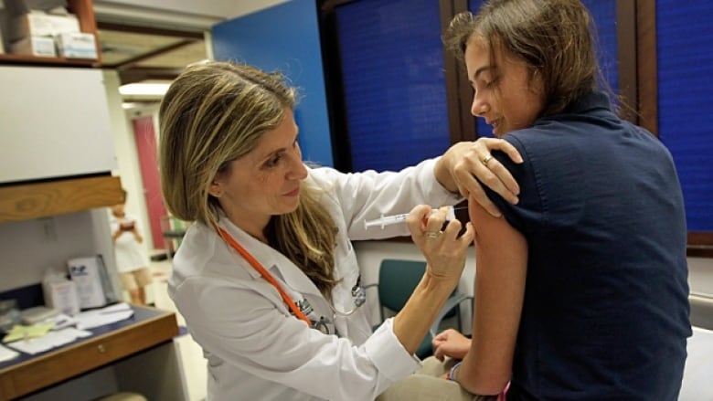 A healthcare provider administers vaccination