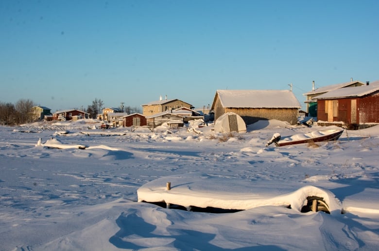 Snow covers boats and homes. 