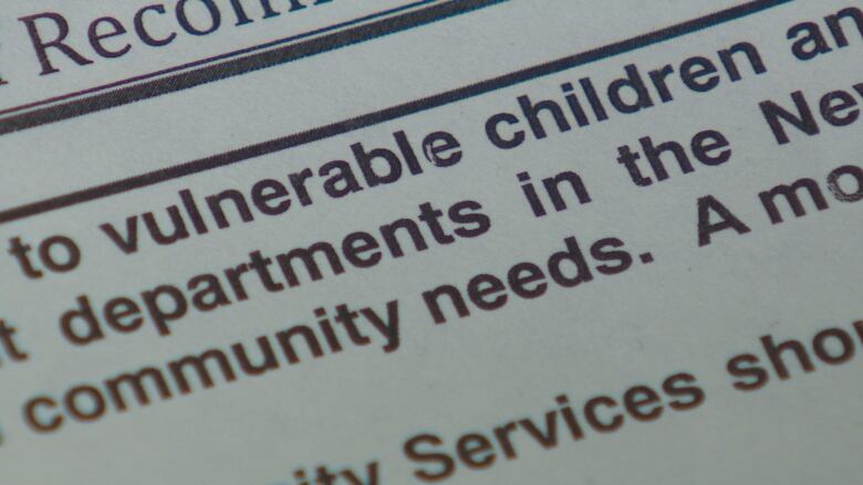 The words 'vulnerable children' are shown on a close-up of a report printed on paper.