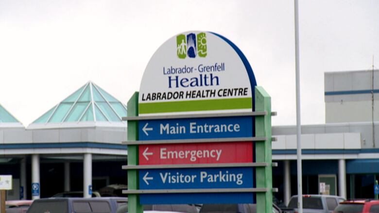 A sign in a hospital parking lot reads 'Labrador Grenfell Health, Labrador Health Centre.'