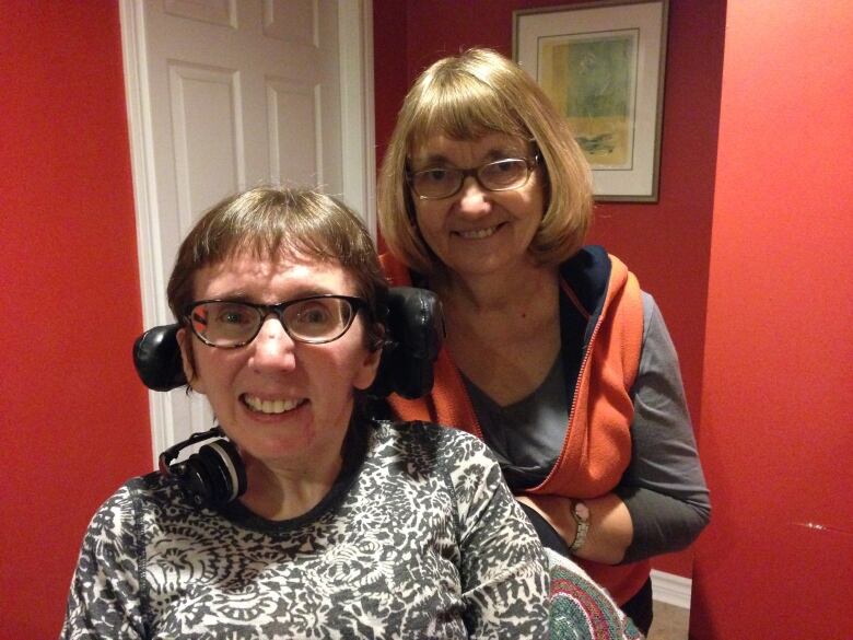 A woman in a wheelchair is shown with her mother.