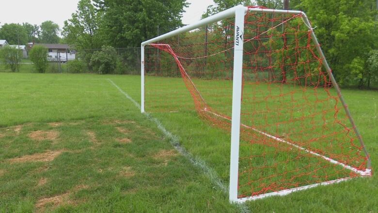 A soccer net on an empty field.