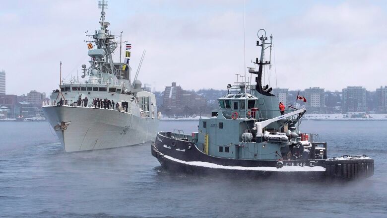 The naval tugboat Glenivis assists as HMCS St. John's heads to the Mediterranean in Halifax on Monday, Jan. 9, 2017. The Halifax-class frigate will be supporting NATO Maritime Group 2 as part of Operation Reassurance.