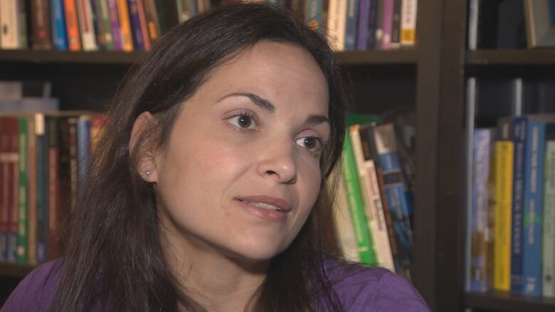 Rosemary Ricciardelli is pictured in front of a bookcase.