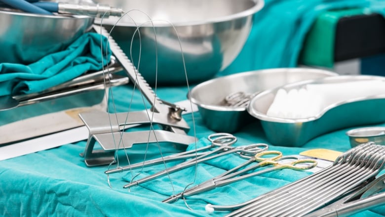 Surgery instruments laid on blue fabric