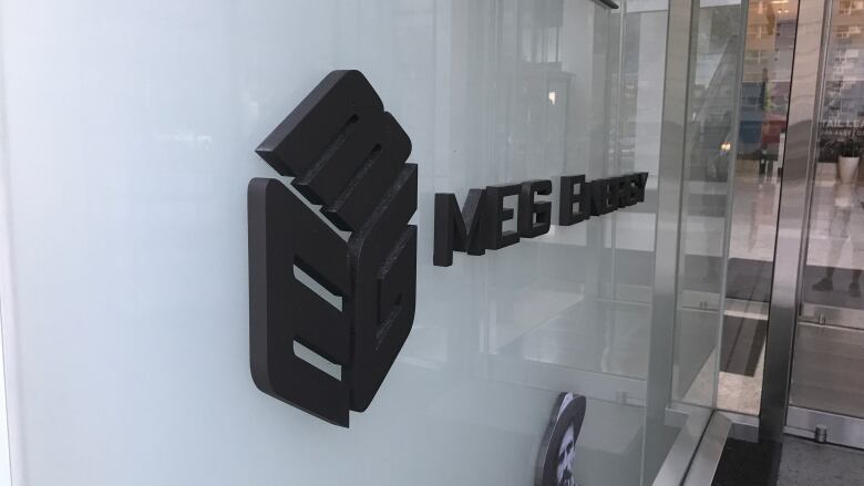 An interior sign in an office building reads MEG Energy.