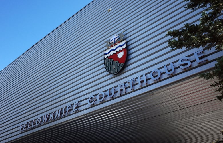 The outside of a building with the sign 'Yellowknife courthouse.'