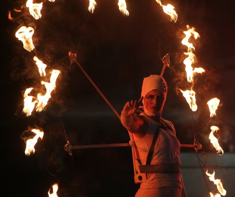 Person does archery with arrow on fire