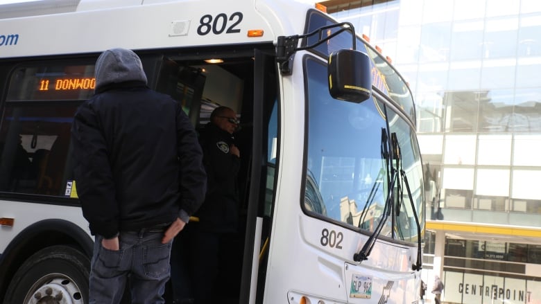 A person is getting on a bus.